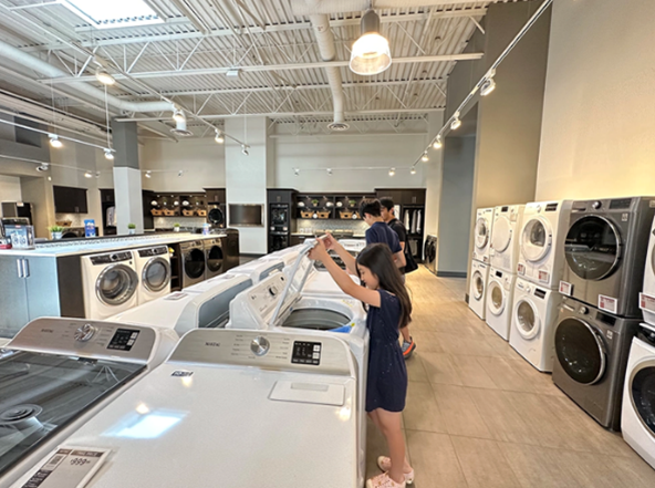 vancity kids looking at washer dryer trail appliances