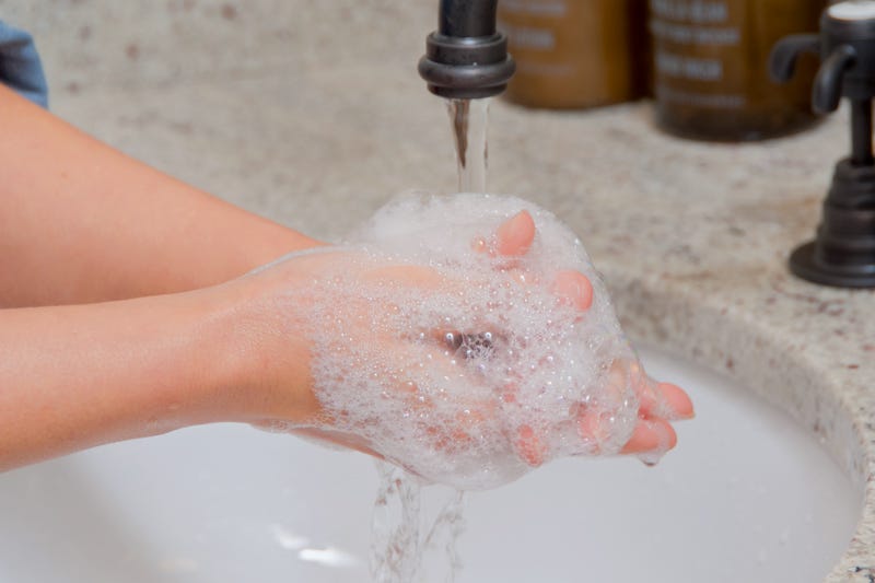 Washing hands in a sink.